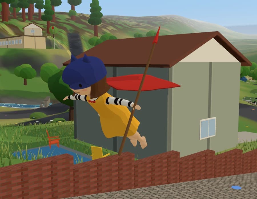 Mab as Super, mid-air in a yellow dress and blue mask with a red cape spread behind her, gliding past a garden shed.